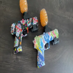 two loaded orbeez pistols, blue and black
